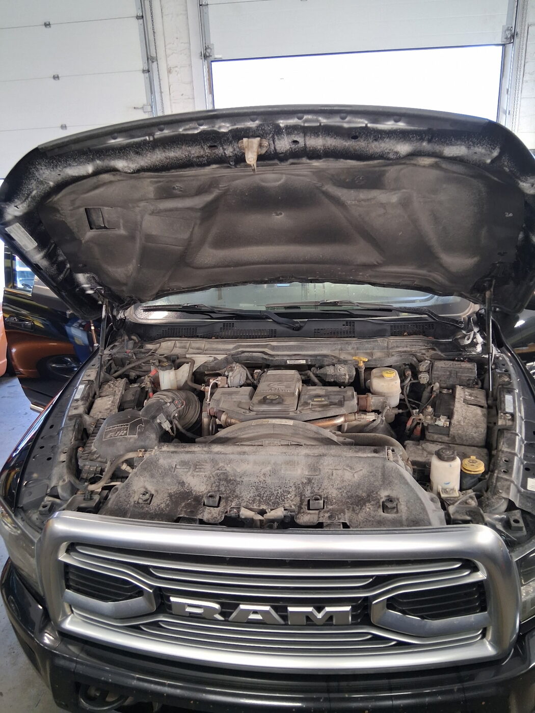 Ram engine bay before — dusty and grimy