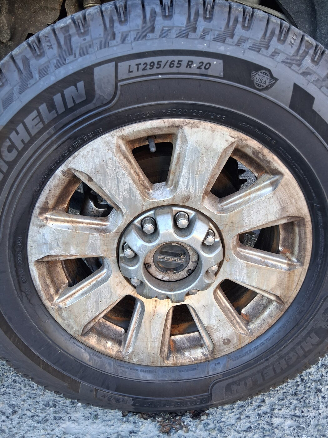 Wheel before — caked brake dust and grime